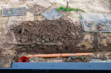 Underground Sewer Pipe Installation at Construction Site.