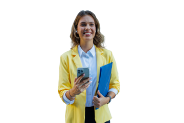 Young businesswoman wearing yellow blazer and wireless earbuds, holding mobile phone and folder, smiling