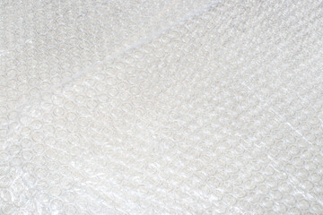 A close-up of bubble wrap, highlighting its texture and protective properties. Textured background