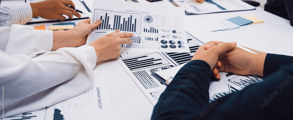 Aufkleber a business team collaborates in a meeting, analyzing charts and graphs on documents. hands engage in