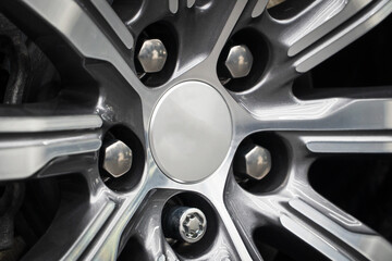 Silver cast disc with a grey caliper. Car Braking System Close-Up of SUV Front Wheel Brake The car wheel with a metallic caliper, pads, brake disc. Car showroom. Car alloy wheel and tyre close-up. 