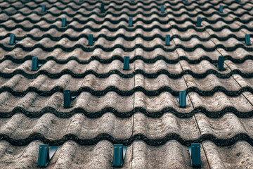 Roof with snow guards on ceramic tiles, designed for safety and winter protection in residential construction.