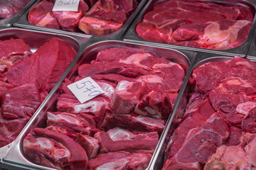 Butcher shop's meat window with meat packs. Different products in meat market. Meat counter.