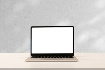 close up isolated on blank screen display of laptop computer on table inside white wall at office room for add content of design banner , website or template or online shopping e-commerce concept