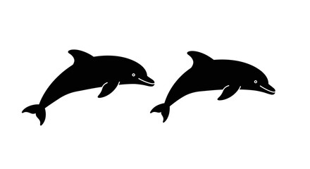 Fototapeta premium Two silhouetted dolphins leaping together gracefully in the ocean waters