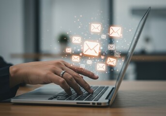 Person s hand typing on a laptop keyboard with digital communication icons floating above the screen representing online messaging and connectivity