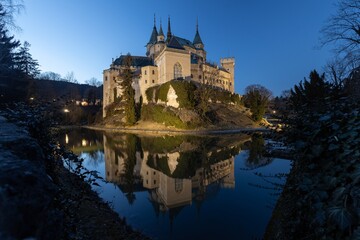 Beautiful famous Bojnice Castle and lake around in Bojnice town during dusk