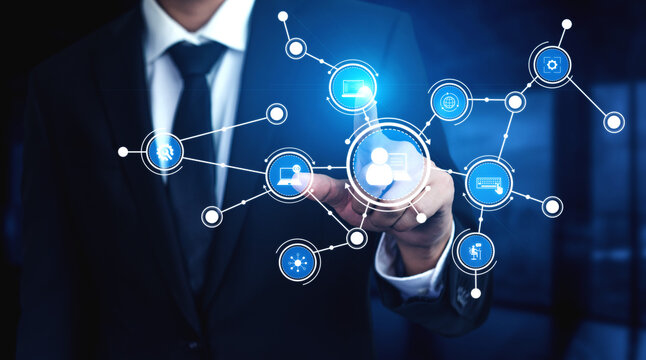 A professional businessman engages with an array of digital network icons, illustrating technology and communication in a sleek office environment, emphasizing modern connectivity. Tessel