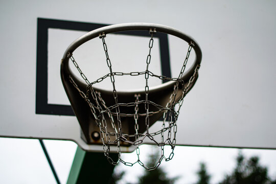 Basketball hoop with metal chain net outdoors