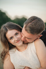 Fototapeta premium Romantic couple embracing in a cornfield, standing forehead to forehead with eyes closed, expressing love, tenderness, and connection in a natural outdoor setting. 