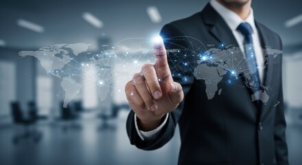 Businessman in suit touches a world map interface in a modern office.