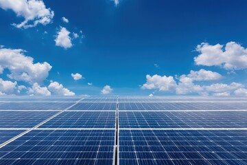 Vast solar panel farm generating clean energy under a beautiful blue sky with fluffy white clouds.