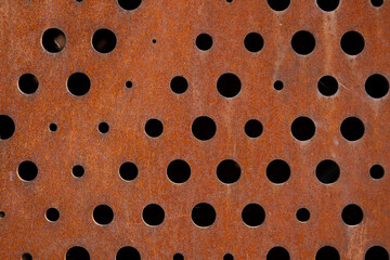 Rusty metal sheet with circular perforations
