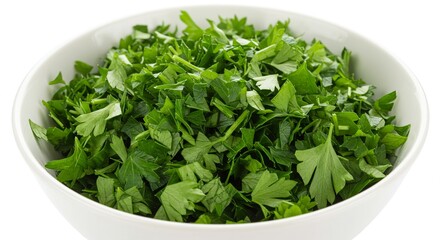 A white bowl overflowing with freshly chopped green parsley against a stark white background.