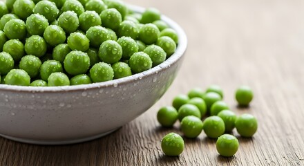 Fresh green peas in a bowl on a wooden table.