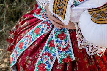 Naklejka premium Traditional czech folk costume (kroj), cultural heritage from the Czech Republic (Czechia, Southern Moravia, Central Europe), the woman wearing the national dress (costume, attire, clothing).