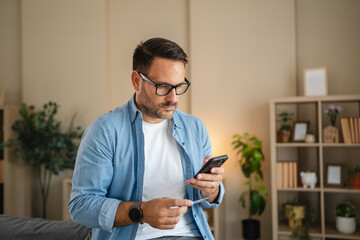 Man holding credit card and smart phone making online payment