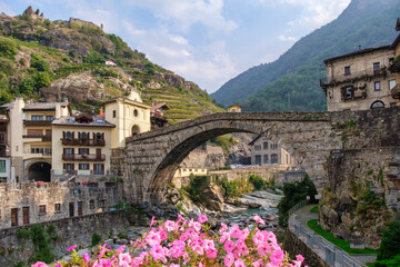 Historic Pont-Saint-Martin bridge in Valle d&rsquo;Aosta, Italy. Scenic Alps, medieval architecture
