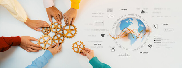 Diverse hands collaborate by assembling gears on a table, representing teamwork and innovation, with digital elements showcasing the impact of technology on global trends. Trope