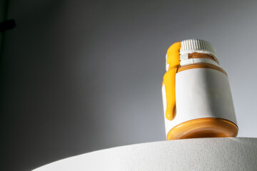 orange acrylic pours out of the bottle, acrylic for painting 