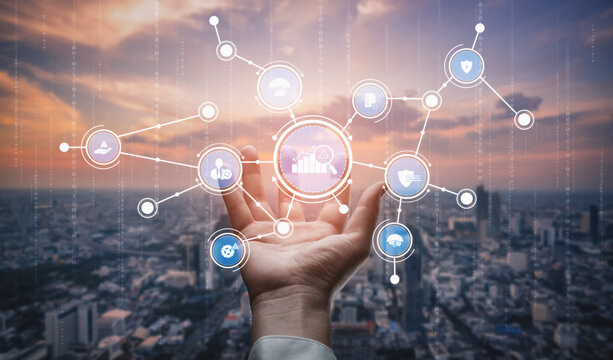 A hand reaches out towards a digital interface filled with icons representing data analysis and technology, all set against a stunning urban skyline at dusk. Tessel