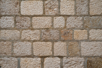 Coursed ashlar limestone wall texture with mortar joints
