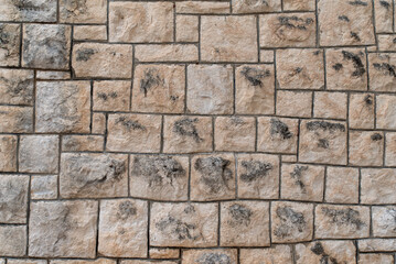 Rough limestone block wall texture with dark mortar joint