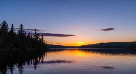 Fototapeta premium Tranquil Lake Reflections Under a Fiery Sunset Sky Over Lush Forested Shores