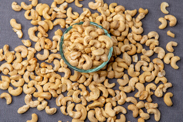 Bowl of cashew nuts on gray background