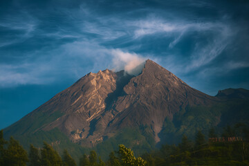 View of the volcano Mount Merapi emitting smoke in the morning with dramatic effect.