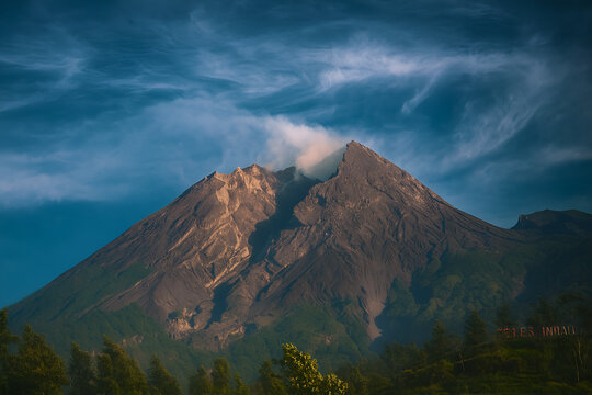View of the volcano Mount Merapi emitting smoke in the morning with dramatic effect.
