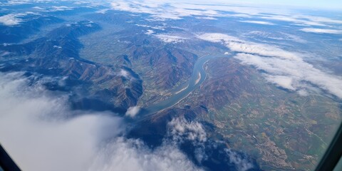 Airplane window view flying over danube river valley