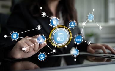 A businesswoman interacts with a digital interface, using innovative technology to visualize data analytics and foster connectivity in a modern office environment. Crux