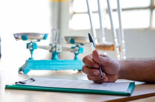 Hand of a man signing a document paper, insurance, legal contract or lawyer consulting. Disability people, attorney or advocate in negotiation, policy advice or accident report closeup