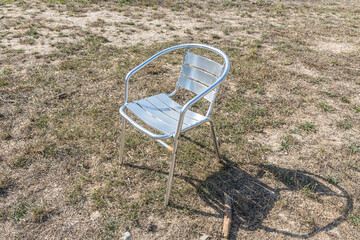 Metallic white chair on the gray background