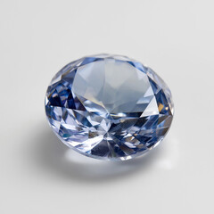 A round faceted light blue sapphire gemstone displayed on a white background, sparkling with brilliance, elegance, and timeless luxury appeal.
