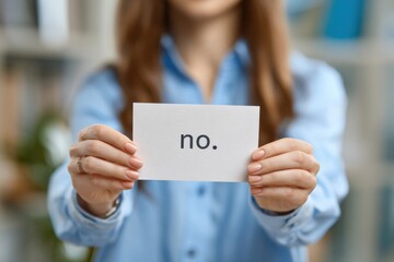 A Close-Up View of a Person Holding a Card with a Simple Yet Powerful Message 'No.' Against a Blurred Background