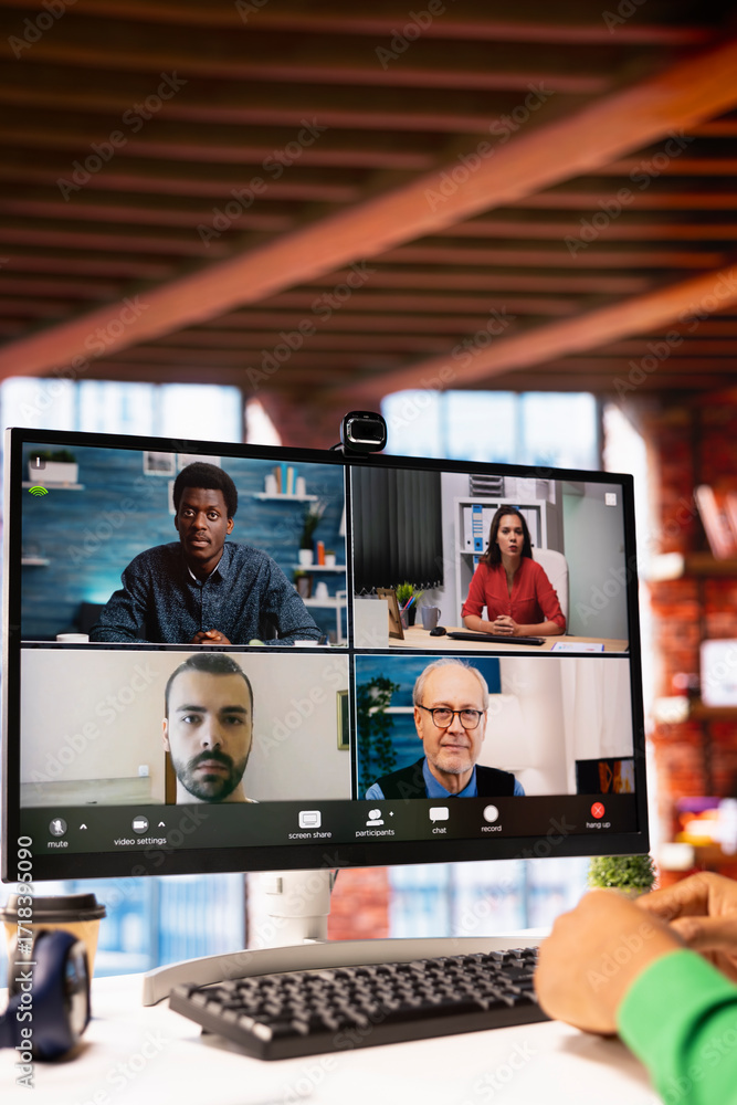 Aufkleber remote worker looking at pc monitor discussing with coworkers during videocall from home. close up o