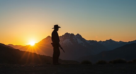 Obraz premium Person silhouette at sunrise over mountain range