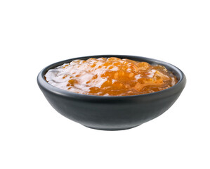 orange jam in a black bowl isolated on white background.