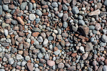 Background texture made of multicolored pebbles in a lake shoreline, Ontario, Canada