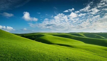Fototapeta premium Rolling Green Hills Under A Clear Blue Sky With Fluffy Clouds