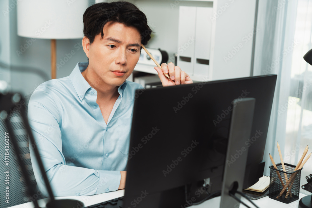 Poster serious smart businessman working on computer to check email with business project report, analyzing