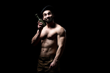 Young Man Holding a Bomb on Black Background