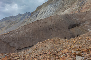 Folds in the dirty, moraine covered ice of Vallelunga Glacier, Alto Adige, Italy. The glacier is in rapid retreat caused by global warming