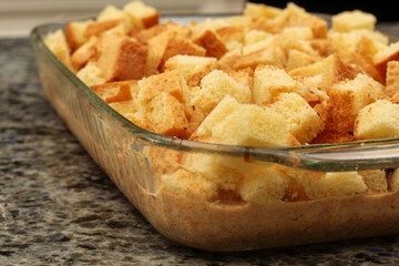 Unbaked Diced Bread Pudding in Baking Dish Ready to Cook