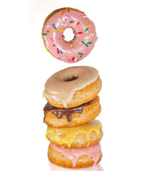Floating Donut Over Stack of Glazed Donuts – Colorful Dessert Composition, Stack of ring donuts with a variety of vibrant icing and toppings, including a floating pink donut with sprinkles. 