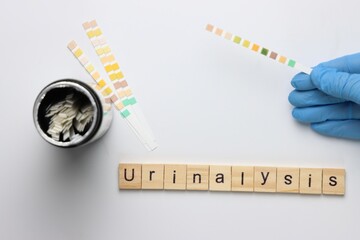 Urinalysis strips to test urine sample in a light background and copy space