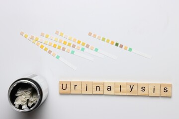 Urinalysis strips to test urine sample in a light background and copy space