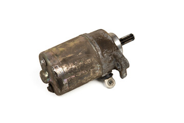 Old rusty motorcycle starter motor isolated on white background, vintage mechanical part for repair and replacement concept.